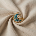 Ring goldfarben mit türkisblauer Welle und Kristallen