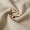 Ring goldfarben mit rotem Kristall
