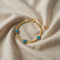 Armband goldfarben mit drei türkisfarbenen Quadraten